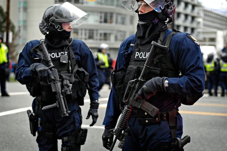 VANCOUVER, BC- 13/02/10 -  Police carry firearms and tear-gas guns during a tense moment of what was called a Heart Attack protest aimed at "clogging the arteries of capitalism." The violent protest snaked through the downtown core of Vancouver, British Columbia, Canada on February 13, 2010, the second day of the Olympics.  Seven people were arrested by police.    Photo by Daniel Hayduk