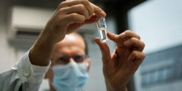A laboratory assistant holds a tube with Russia's "Sputnik-V" vaccine against the coronavirus disease (COVID-19) at the National Institute of Pharmacy and Nutrition in Budapest, Hungary, November 19, 2020. Matyas Borsos/Hungarian Foreign Ministry/Handout via REUTERS  THIS IMAGE HAS BEEN SUPPLIED BY A THIRD PARTY. NO RESALES. NO ARCHIVES