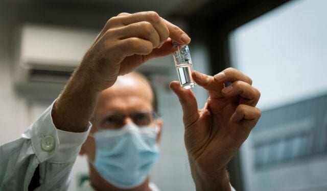 A laboratory assistant holds a tube with Russia's "Sputnik-V" vaccine against the coronavirus disease (COVID-19) at the National Institute of Pharmacy and Nutrition in Budapest, Hungary, November 19, 2020. Matyas Borsos/Hungarian Foreign Ministry/Handout via REUTERS  THIS IMAGE HAS BEEN SUPPLIED BY A THIRD PARTY. NO RESALES. NO ARCHIVES