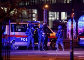Police officers stand guard on a street after exchanges of gunfire in Vienna, Austria November 3, 2020. REUTERS/Leonhard Foeger