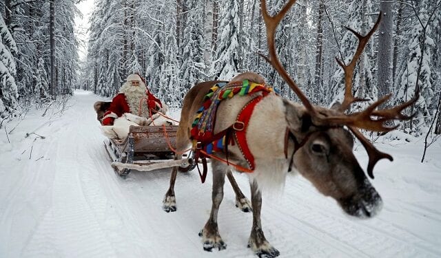 FILE PHOTO: Santa Claus rides in his sleigh as he prepares for Christmas in the Arctic Circle near Rovaniemi, Finland December 15, 2016. REUTERS/Pawel Kopczynski/File Photo