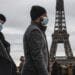 People wearing face makes to protect against the COVIS-19 walk at Trocadero plaza near Eiffel Tower in Paris, Saturday, Dec. 26, 2020. French health authorities have confirmed the country's first case of the virus variant that prompted strict new lockdown measures in Britain and global travel restrictions.(AP Photo/Michel Euler)