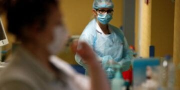 Nurses, wearing protective masks and protective suits, work in a Covid-19 medicine unit where patients suffering from the coronavirus disease (COVID-19) are treated at the Bethune-Beuvry hospital in Beuvry, France, October 16, 2020. REUTERS/Pascal Rossignol