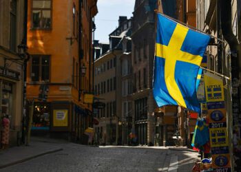 Swedish flags fly from a tourist souvenir shop in Gamla Stan in Stockholm, Sweden, on Thursday, March 26, 2020. Sweden is starting to look like a global outlier in its response to the coronavirus. Photographer: Mikael Sjoberg/Bloomberg